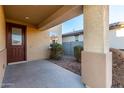 Covered front porch with a brown door and small landscaping at 5656 N 109Th Ave, Phoenix, AZ 85037