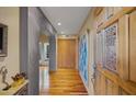 Long hallway with hardwood floors and arched doorway at 5777 N 78Th Pl, Scottsdale, AZ 85250