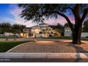 Elegant home exterior at dusk, showcasing architectural details and landscaping at 6601 E Valley Vista Ln, Paradise Valley, AZ 85253