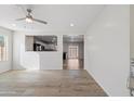 Bright and airy living room with wood-look flooring and an open floor plan at 7504 S Sundown Ct, Buckeye, AZ 85326