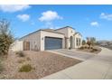 View of the home's side elevation, showcasing the garage and landscaping at 8448 W Candlewood Way, Florence, AZ 85132