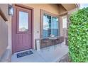 Small front porch with seating for two and lush greenery at 9022 W Ross Ave, Peoria, AZ 85382