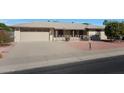 House exterior showcasing a garage and neatly landscaped front yard at 10240 W Oak Ridge Dr, Sun City, AZ 85351