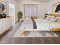 Bright and airy main bedroom with a dresser and large bed at 13033 W Avalon Dr, Avondale, AZ 85392