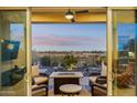 Relaxing patio with fire pit and seating area, overlooking backyard at 2317 N Beverly Pl, Buckeye, AZ 85396