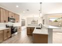 Modern kitchen with light wood cabinets and quartz countertops at 3143 E Morenci Rd, San Tan Valley, AZ 85143