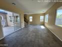 Bright living room featuring tile floors, large windows, and access to the backyard patio at 359 N 157Th Ln, Goodyear, AZ 85338
