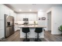 Modern kitchen with white cabinets, stainless steel appliances, and a large island at 5356 N 205Th Dr, Buckeye, AZ 85396