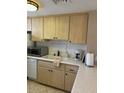 Well-equipped kitchen featuring double sink and wood cabinets at 6125 E Indian School Rd # 197, Scottsdale, AZ 85251