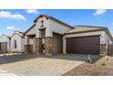 Charming house with a brick driveway and a 2-car garage at 685 E Greenback Dr, San Tan Valley, AZ 85140