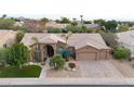 Single-story home with a two-car garage and manicured landscaping at 9353 N 113Th Way, Scottsdale, AZ 85259