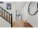 Bright entryway with modern staircase and wood-look floors at 9540 E Spiral Ave, Mesa, AZ 85212