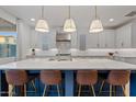 Modern kitchen with white cabinets, blue island, and quartz countertops at 9540 E Spiral Ave, Mesa, AZ 85212