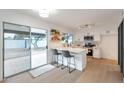 Modern white kitchen with breakfast bar and stainless steel appliances at 1015 W Minton Dr, Tempe, AZ 85282