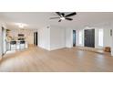 Bright and airy living room with light wood floors and modern ceiling fan at 1015 W Minton Dr, Tempe, AZ 85282