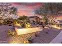 Landscaped yard with desert plants, lighting, and rock features at 1075 W Desert Aster Rd, San Tan Valley, AZ 85143