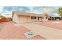 Charming single story home with a spacious driveway and rock landscaping at 11440 N Hagen Dr, Sun City, AZ 85351