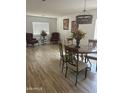 Elegant dining room featuring hardwood floors and modern light fixture at 11621 W Cheryl Dr, Youngtown, AZ 85363