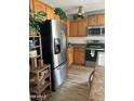 Modern kitchen with stainless steel appliances and oak cabinets at 11621 W Cheryl Dr, Youngtown, AZ 85363