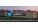 Alamar community entrance with mountain views at dusk at 12517 W Trumbull Rd, Avondale, AZ 85323