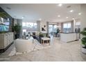 Open concept living room, kitchen, and dining area with herringbone floors at 13183 N 145Th Ln, Surprise, AZ 85379