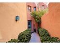 Inviting entryway with a teal door and well-manicured landscaping at 13227 N Mimosa Dr # 117, Fountain Hills, AZ 85268