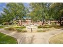 Villa Del Coronado community entrance with landscaping and a paved pathway at 148 E Coronado Rd # 45, Phoenix, AZ 85004