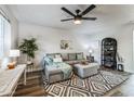 Living room featuring a gray sectional sofa and a ceiling fan at 1531 W Colter St # 7, Phoenix, AZ 85015