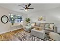 Living room with gray sectional sofa and large window at 1531 W Colter St # 7, Phoenix, AZ 85015