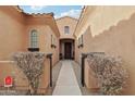 Elegant entryway with gated courtyard and pathway at 18109 W Juniper Dr, Goodyear, AZ 85338