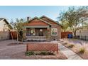 Renovated craftsman bungalow with a welcoming front porch and attractive landscaping at 1815 N Dayton St, Phoenix, AZ 85006