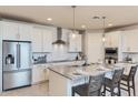 Modern kitchen with stainless steel appliances and white cabinets at 18202 W Cielo Grande Ave, Surprise, AZ 85387