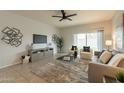 Living room with gray couch and access to backyard at 18972 W Woodlands Ave, Buckeye, AZ 85326