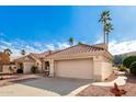 View of the home's exterior, highlighting the garage and walkway at 19619 N White Rock Dr, Sun City West, AZ 85375