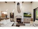 Spacious living room featuring a large fireplace and comfortable seating at 19627 N 101St St, Scottsdale, AZ 85255