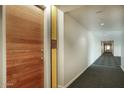 Modern hallway with wood door and carpet flooring at 200 W Portland St # 817, Phoenix, AZ 85003