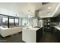 Open concept kitchen with island, stainless steel appliances, and dark wood cabinets at 200 W Portland St # 817, Phoenix, AZ 85003