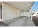 Covered carport area adjacent to the house with a white fence at 201 S Greenfield Rd # 353, Mesa, AZ 85206