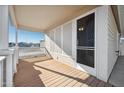 Bright and airy front porch with wooden flooring and screen door at 201 S Greenfield Rd # 353, Mesa, AZ 85206