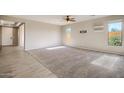 Spacious living room with tile and carpeted floors and large windows at 29302 N 126Th Ln, Peoria, AZ 85383