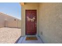 Red front door with a woven wreath and a welcome mat at 3751 E Archer Dr, San Tan Valley, AZ 85140