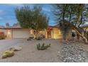 Desert landscape with charming one-story home, featuring a two-car garage at 3755 N 161St Ave, Goodyear, AZ 85395