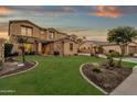 Two-story house with stone accents, landscaped lawn, and basketball court at 3829 E Sawtooth Dr, Chandler, AZ 85249