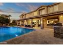 Inviting swimming pool with spacious patio and outdoor kitchen at 3829 E Sawtooth Dr, Chandler, AZ 85249