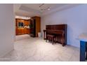 Kitchen with wood cabinets and tile floor, view into living area at 4200 N Miller Rd # 121, Scottsdale, AZ 85251