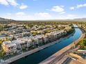 Aerial view of community by a canal with mountain views at 4803 N Woodmere Fairway -- # 2002, Scottsdale, AZ 85251