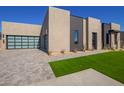 Modern home exterior showcasing a sleek design and two-car garage at 5740 E Moura Dr, Cave Creek, AZ 85331