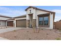 Single story home with modern facade and desert landscaping at 671 E Greenback Dr, San Tan Valley, AZ 85140