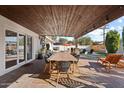 Covered patio with a large dining table and comfortable seating at 7529 E Windsor Ave, Scottsdale, AZ 85257