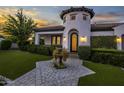 Stunning curb appeal at sunset, featuring a circular driveway at 8400 E Columbus Ave, Scottsdale, AZ 85251